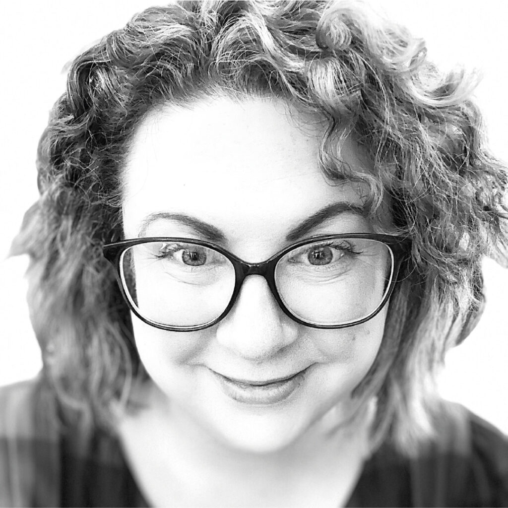 Eve Sturdy (from Sturdy Socials and Design) headshot, smiling in glasses